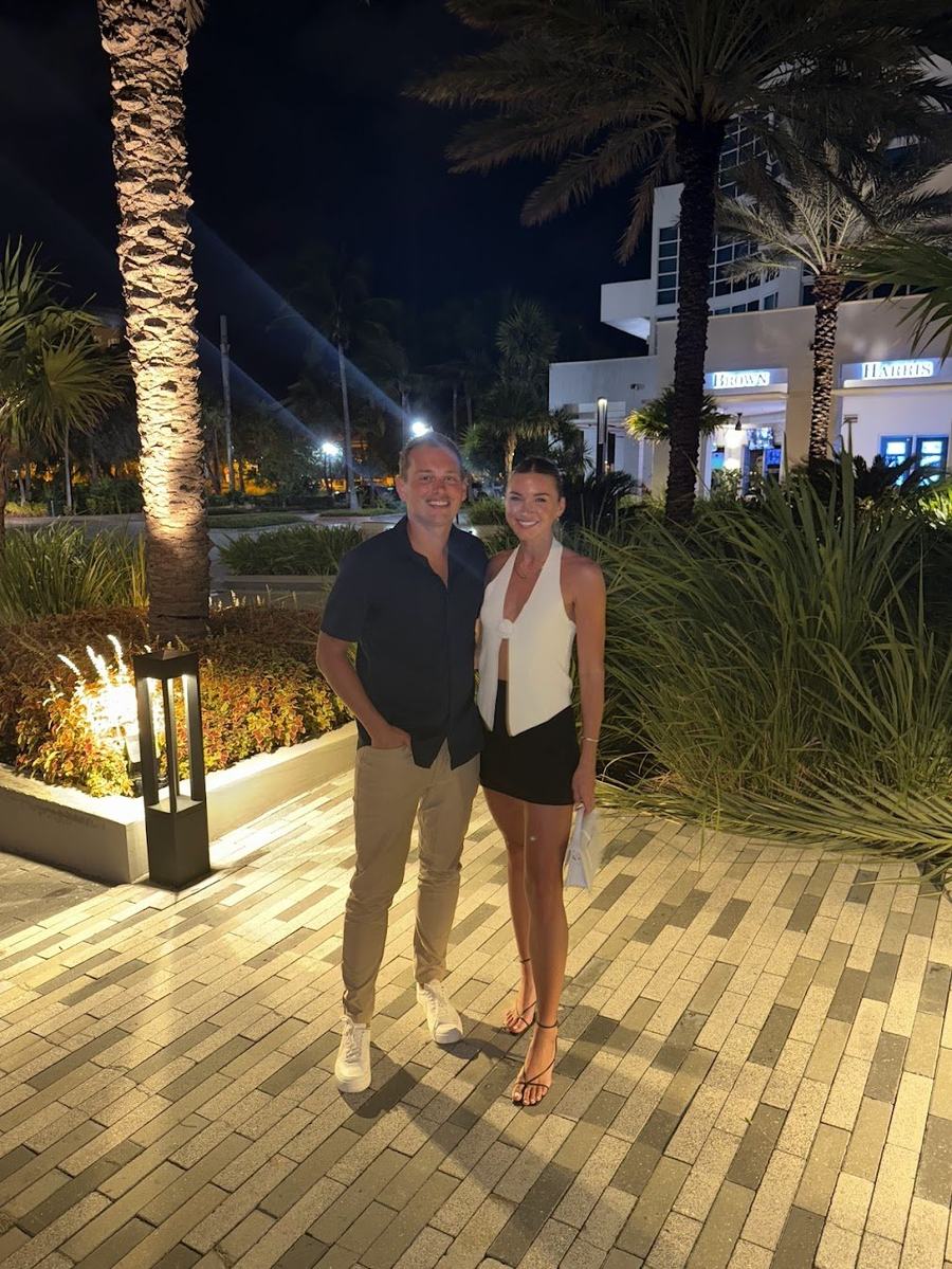 Will Tjernlund and Kelsey in Miami, Florida, at a tropical hotel promenade at night
